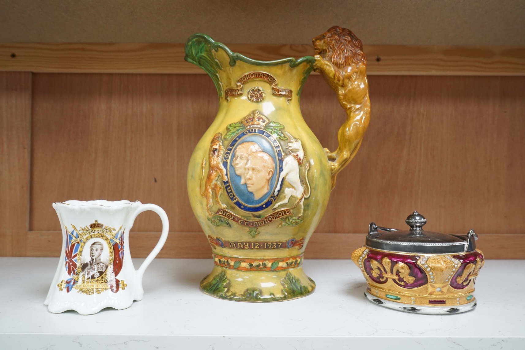 A Crown Devon George VI musical coronation jug, a crown shaped jar with plated cover and a coronation cup, largest 32cm high